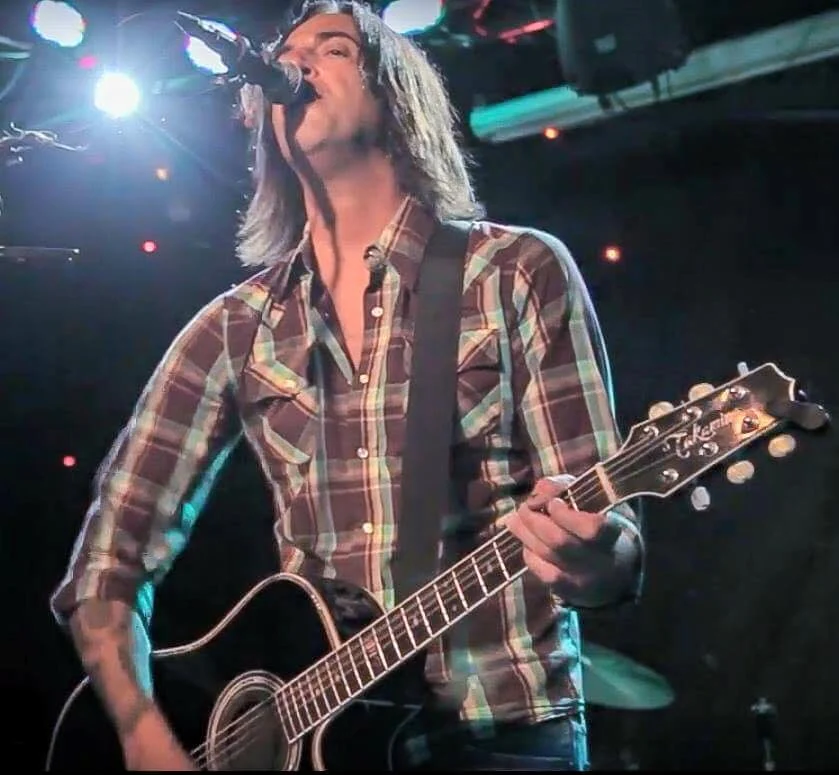 Anthony Picone singing and playing guitar at Mexicali Live