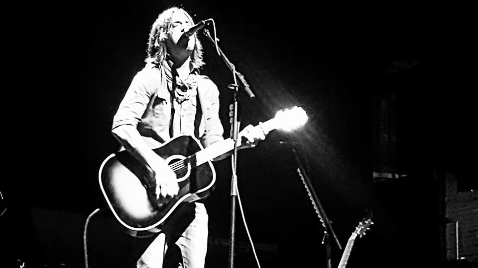 Anthony Picone performing with an acoustic guitar at Bergen PAC